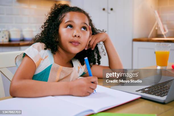 shot of a little girl daydreaming while doing her homework - young girls homework stock pictures, royalty-free photos & images