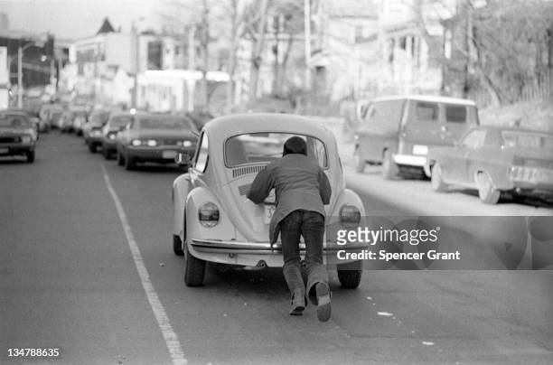 Drivers push cars to a gas station during the oil crisis of 1973-74, Roslindale, Boston, Massachusetts, 1973.