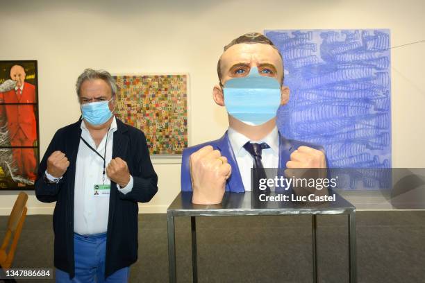 Galerist Albert Baronian poses with the Work of Artist Wang Du "New Photo d'Identité 2021" during the FIAC 2021 - International Contemporary Art Fair...