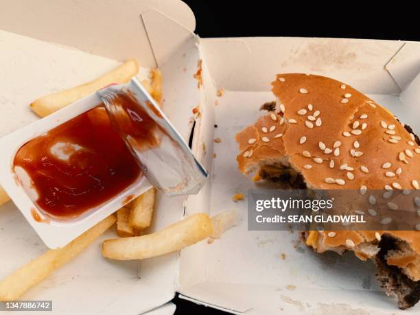 half eaten hamburger and ketchup - french fries ketchup stock pictures, royalty-free photos & images