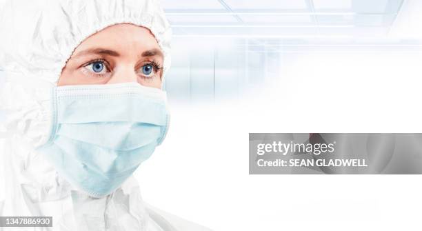 person in cleanroom coverall - protective suit stock pictures, royalty-free photos & images