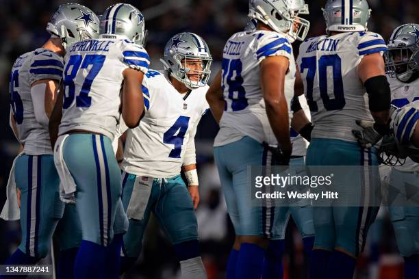 Dak Prescott of the Dallas Cowboys in the huddle during a game against the New York Giants at AT&T Stadium on October 10, 2021 in Arlington, Texas....