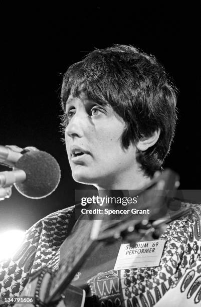 Pregnant Joan Baez sings at Harvard Stadium, Brighton, Boston, Massachusetts, 1969.