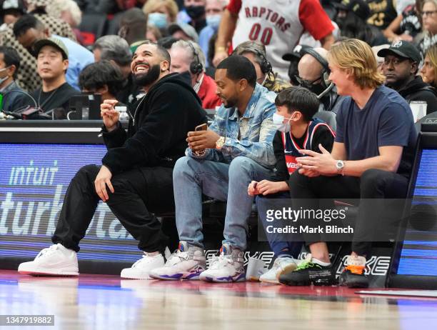 Drake smiles during a basketball game between the Toronto Raptors and the Washington Wizards Scotiabank Arena on October 20, 2021 in Toronto, Canada....