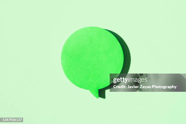 green blank note in the shape of comic bubbles on green background - chat bubble stock pictures, royalty-free photos & images