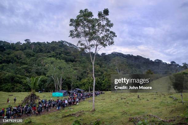 Immigrants from Haiti depart a base camp for their trek through Darien Gap on October 18, 2021 at Las Tekas, Colombia. The 66-mile passage through...