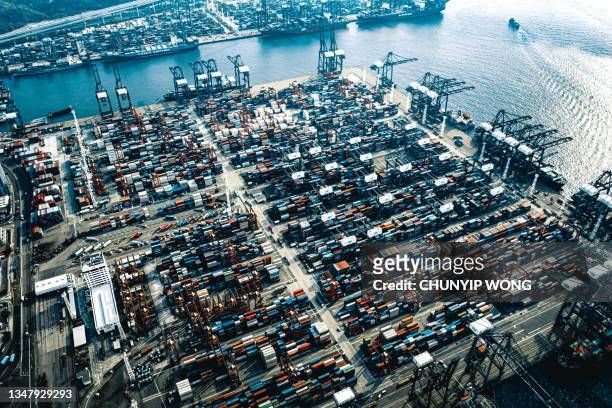 cranes and shipping containers at the port of hong kong - global trade war stock pictures, royalty-free photos & images