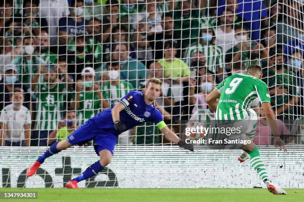 Borja Iglesias of Real Betis scores their side's first goal from the penalty spot past Lukas Hradecky of Bayer 04 Leverkusen during the UEFA Europa...