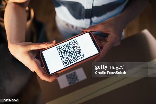 anonymous businesswoman scanning a qr code using her smartphone - medical scanning equipment stock pictures, royalty-free photos & images