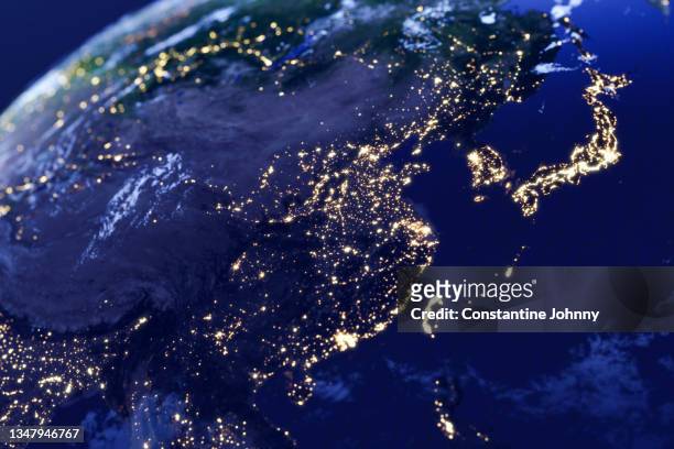 east asia night lights view from space - wandelschoenen stock-fotos und bilder