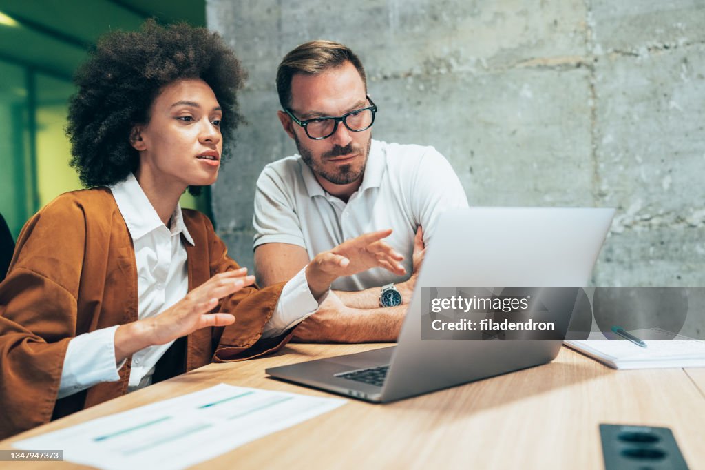 Two business people working together in office