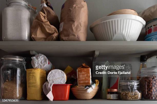 kitchen shelves with various food items in bags and jars - pantry shelf stock pictures, royalty-free photos & images