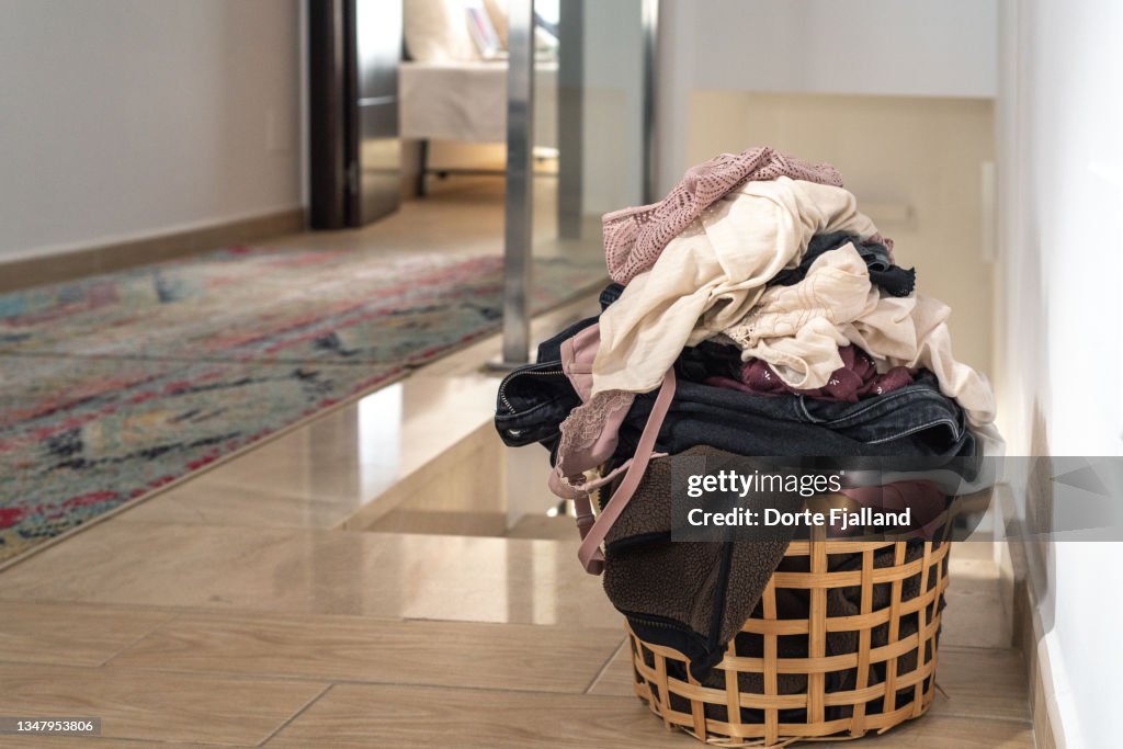 Basket with laundry on a tiled floor