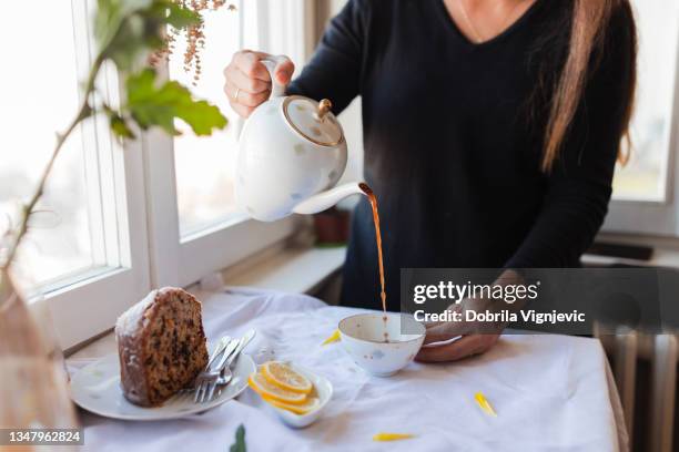 woman pouring coffee from a coffee pot - freshly brewed coffee stock pictures, royalty-free photos & images