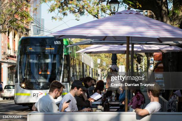 People enjoy outdoor dining on Gertrude street in Fitzroy on October 22, 2021 in Melbourne, Australia. Lockdown restrictions have lifted in Melbourne...