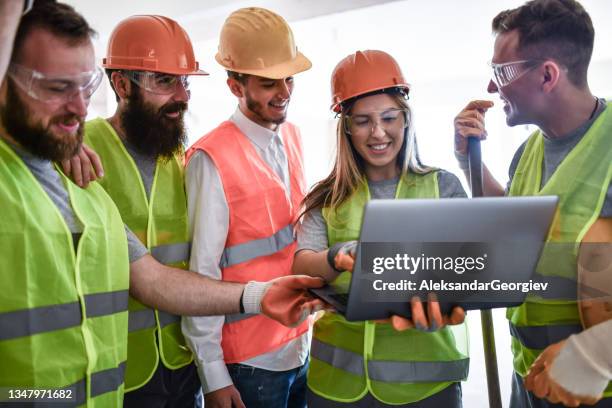 happy team of architect, civil engineer and construction workers examining building projection - safety funny stock pictures, royalty-free photos & images