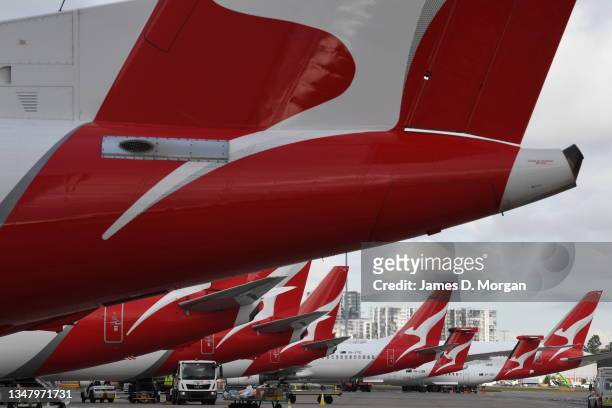 Qantas aircraft tails on the tarmac at Kingsford Smith Airport on October 22, 2021 in Sydney, Australia. Qantas announced today that all...