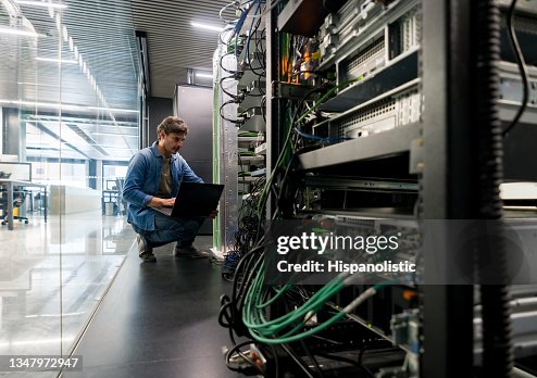Computer technician fixing a network server at the office Computer technician fixing a network server at the office