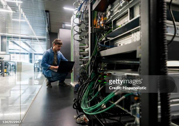 computer technician fixing a network server at the office - bitcoin mining stock pictures, royalty-free photos & images