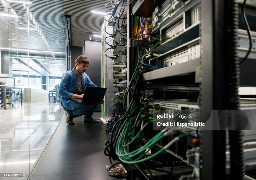 Computer technician fixing a network server at the office