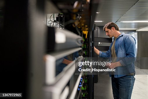 IT support technician fixing a network server IT support technician fixing a network server