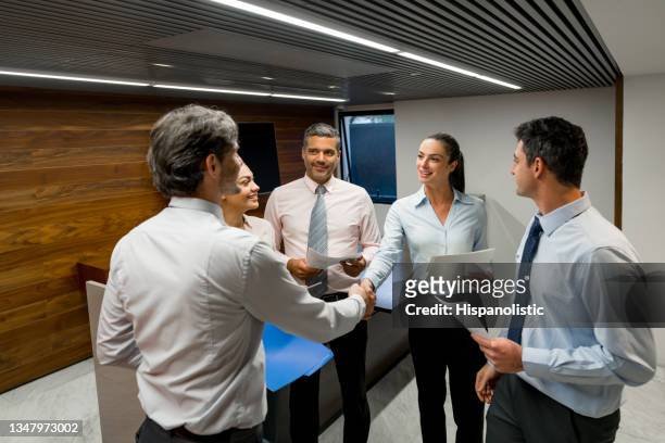 boss congratulating a business woman for her good performance - pact for mexico stock pictures, royalty-free photos & images