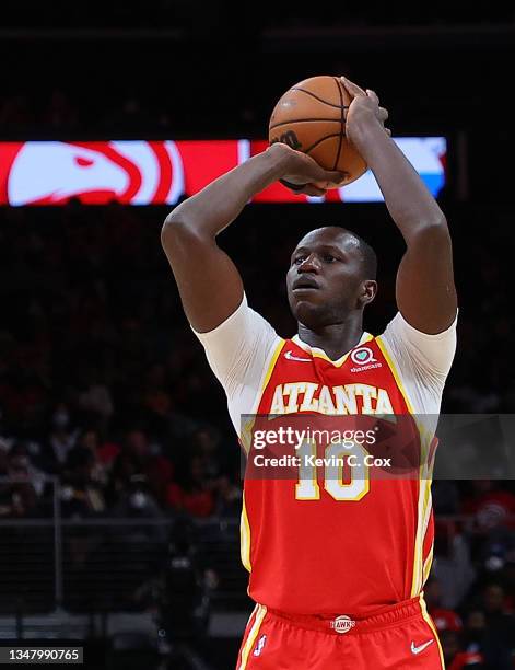Gorgui Dieng of the Atlanta Hawks shoots a three-point basket against the Dallas Mavericks during the second half at State Farm Arena on October 21,...