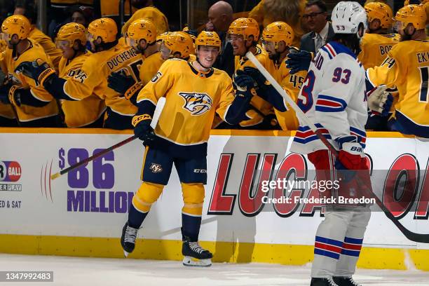 Philip Tomasino of the Nashville Predators is congratulated by teammates after scoring his first career NHL goal against the New York Rangers during...