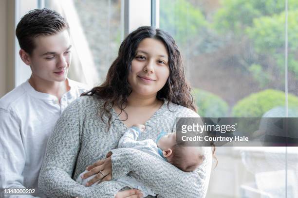 young parents with newborn - teen pregnancy stock pictures, royalty-free photos & images