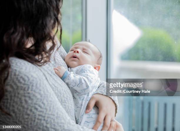 single mom holding newborn - teenage pregnancy stock pictures, royalty-free photos & images
