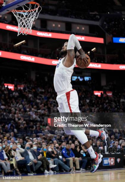 Paul George of the LA Clippers goes up for a slam dunk against the Golden State Warriors during the third quarter at Chase Center on October 21, 2021...
