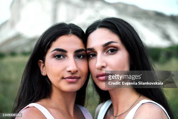 two girls friends embracing outdoors. close-up. - indian faces stock pictures, royalty-free photos & images