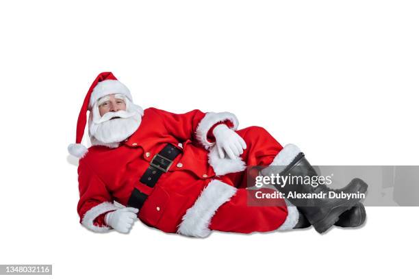 christmas santa claus lies resting on a white background studio with copy space. new year concept and sale - santa claus lying stockfoto's en -beelden