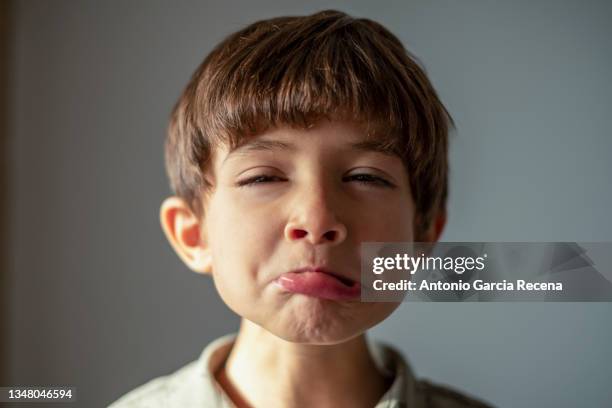 child makes an expression of exaggerated sadness - funny face stock pictures, royalty-free photos & images