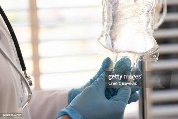 heart shape with doctor - iv drip stock pictures, royalty-free photos & images