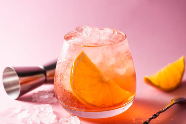 orange cocktail with ice in glass - orange cocktail stock pictures, royalty-free photos & images