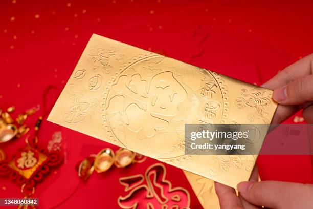 chinese new year decoration on a red background flag of good fortune and lump of gold - gold envelope stock pictures, royalty-free photos & images