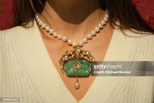 Mughal carved emerald pendant set with enamelled parrot-shaped mounts, India, 19th Century, with later pearl necklace, estimate 30,000 - 50,000 GBP...