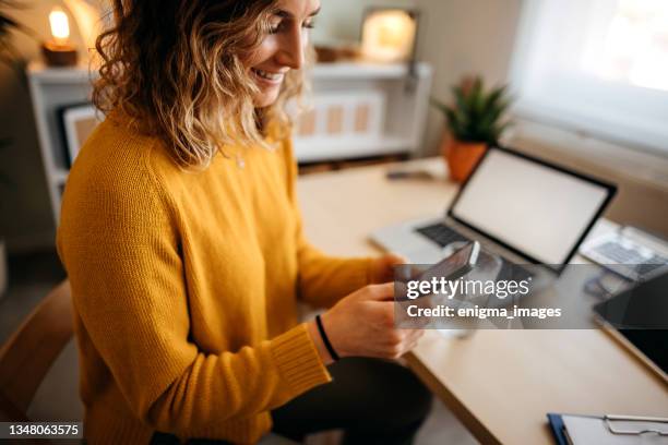 young woman in a home office - customer engagement stock pictures, royalty-free photos & images