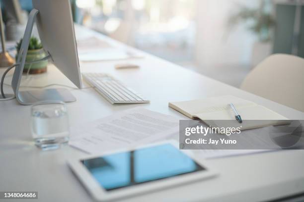 shot of various items on a desk in an empty modern office - jay space stock pictures, royalty-free photos & images