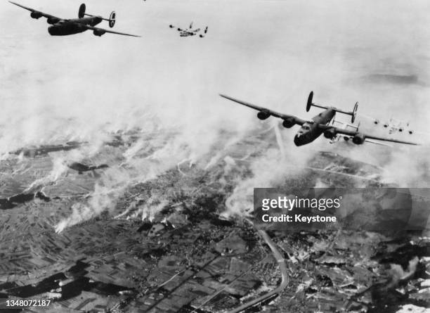 Consolidated B-24 Liberator heavy bombers from the 460th Bombardment Group of the United States Army Air Forces Fifteenth Air Force, drop their...