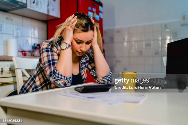 upset young woman frustrated with financial problems - poor kitchen stock pictures, royalty-free photos & images