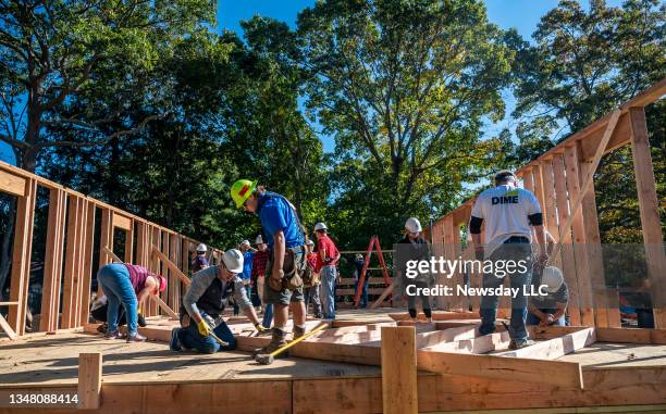 Members of Habitat for Humanity of Suffolk join together to build a home for a family, in Shirley, New York, on October 21, 2021.