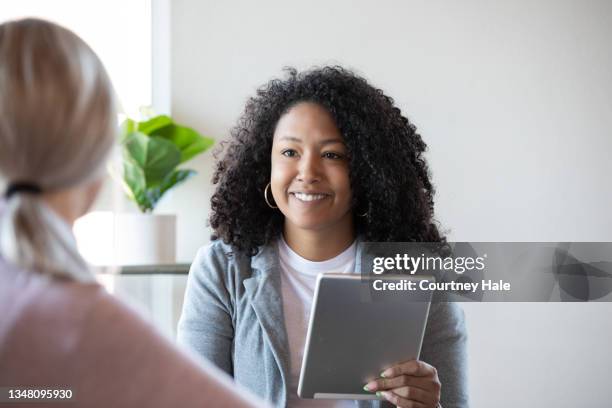 woman consulting with university student about financial aid or student loan options - student loan stockfoto's en -beelden