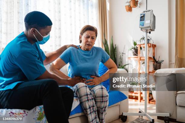 abdominal pain patient woman having medical exam with doctor on illness from stomach cancer, irritable bowel syndrome, pelvic discomfort, indigestion, diarrhea, gerd (gastro-esophageal reflux disease) - menstrual pain stockfoto's en -beelden