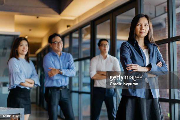 confidence businesswoman and her team in office - chairman stock pictures, royalty-free photos & images