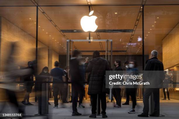 People wait outside the entrance to the new Apple retail store after its opening on Bagdat Caddesi on October 22, 2021 in Istanbul, Turkey. The new...