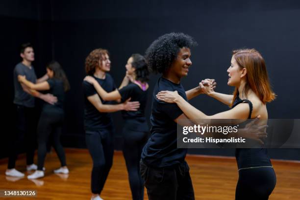 happy couples taking dancing lessons in a studio - salsa dancer stock pictures, royalty-free photos & images