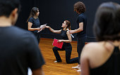 Acting coach directing an improv exercise with her students in a drama class