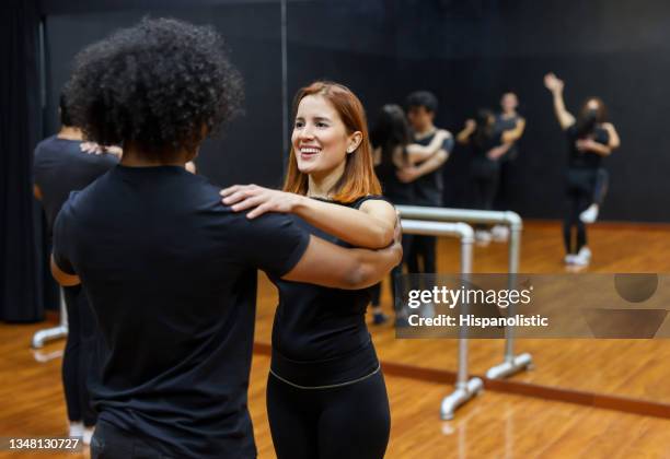 happy couple taking dancing lessons - salsa dancing stockfoto's en -beelden